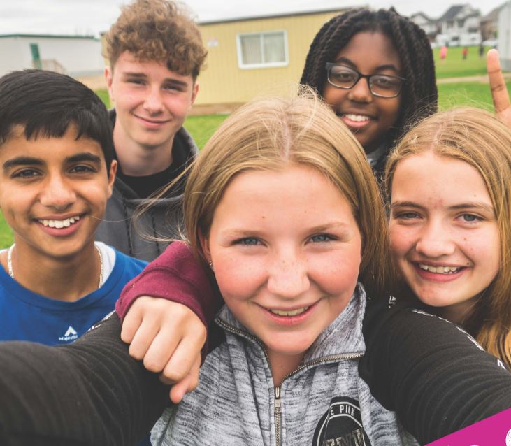 A group of Grade 8 students take a selfie